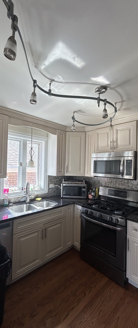 5810 South Austin Avenue Chicago, IL 60638 - Photo 4 of 11 a kitchen with stainless steel appliances granite countertop a sink cabinets and wooden floor