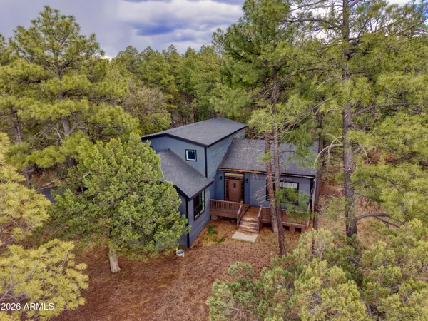 an aerial view of a house with a yard