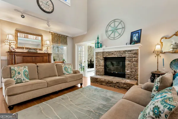 a living room with furniture a fireplace and a rug