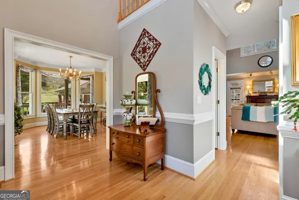 a view of a room with a large window and wooden floor