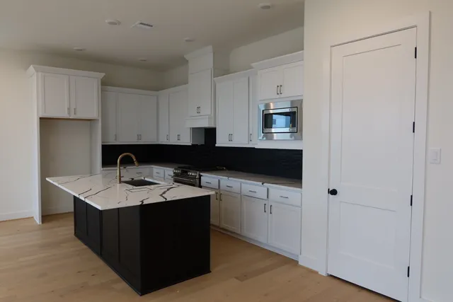 a kitchen with a sink and cabinets