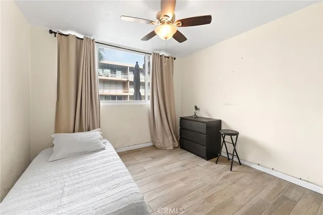 a bedroom with a bed and wooden floor