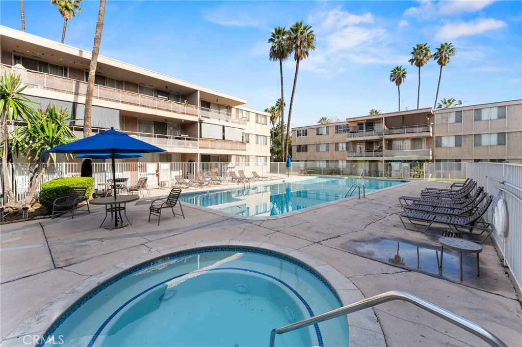 6979 Palm Court Riverside, CA 92506 - Photo 25 of 28 a view of a swimming pool with a table and chairs under an umbrella
