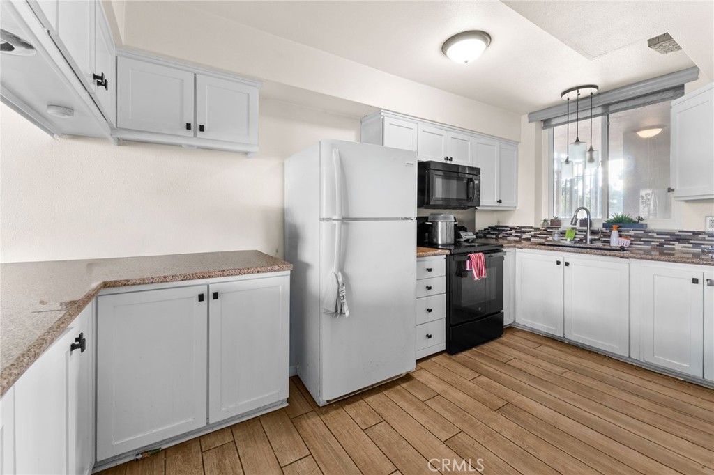 6979 Palm Court Riverside, CA 92506 - Photo 5 of 28 a kitchen with stainless steel appliances a refrigerator sink and microwave