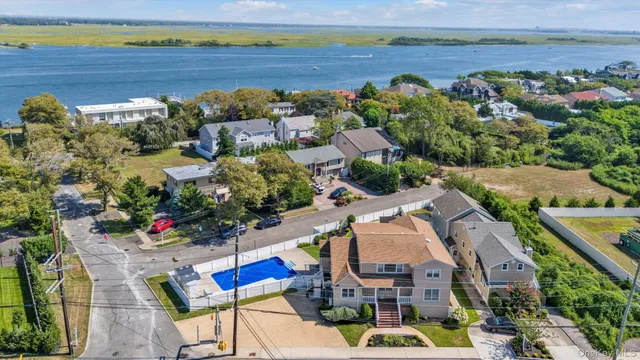 an aerial view of a house with a lake view