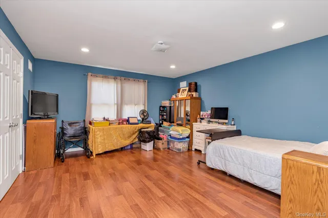 a bedroom with furniture and a wooden floor