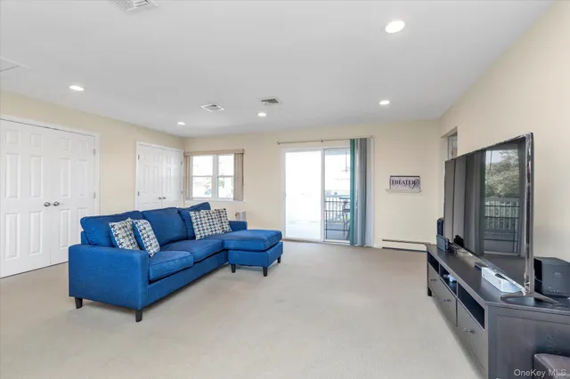 a living room with furniture window and a flat screen tv