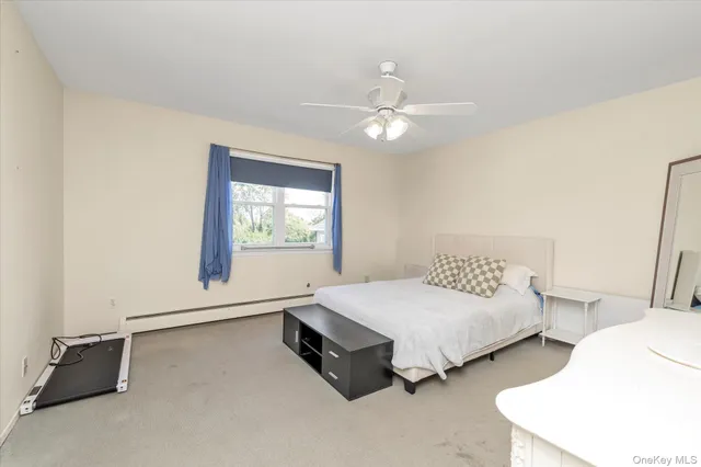 a spacious bedroom with two bed and a window