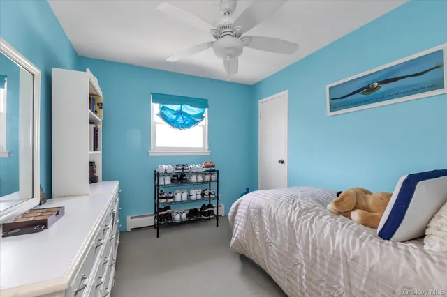 a bedroom with a bed and a desk