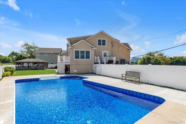 a view of a house with pool and a yard