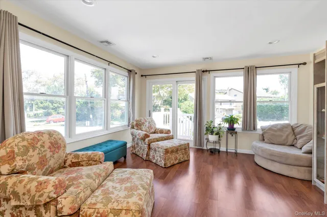 a spacious bedroom with large bed and large windows