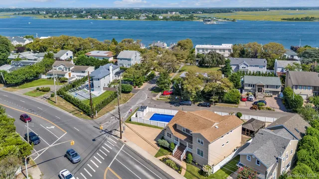 an aerial view of a house with a lake view