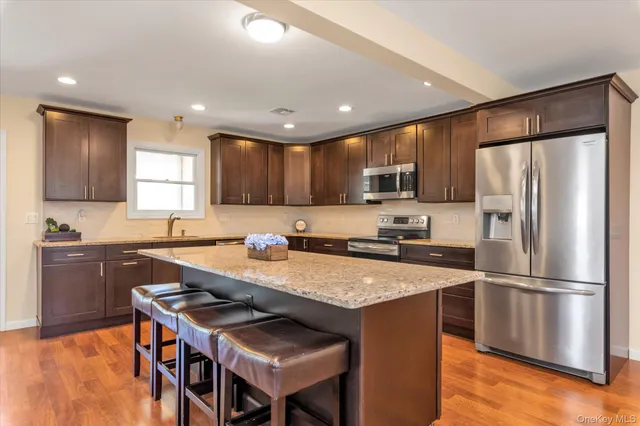 a kitchen with a refrigerator a stove a sink and a refrigerator