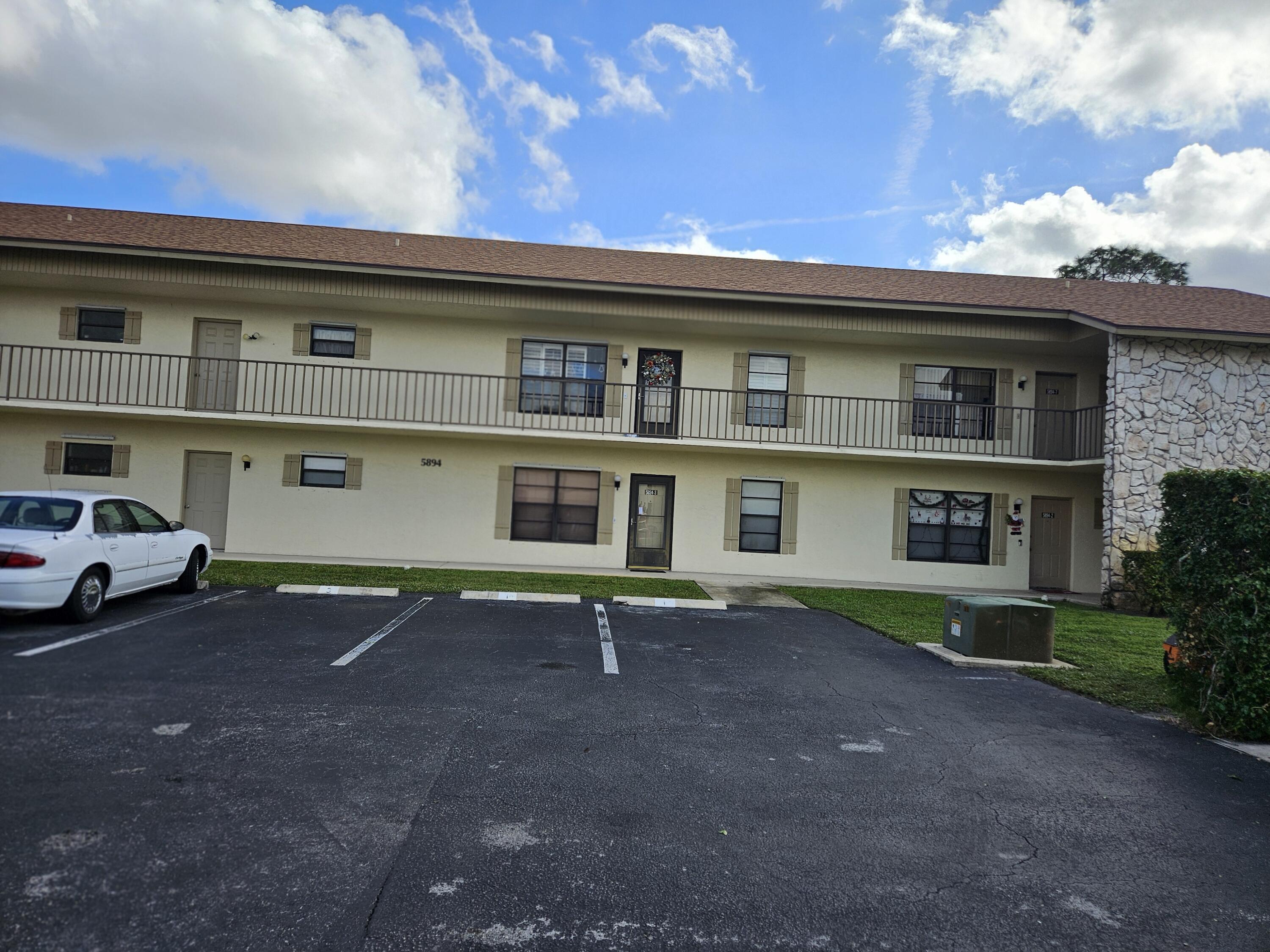 a front view of a house with parking space