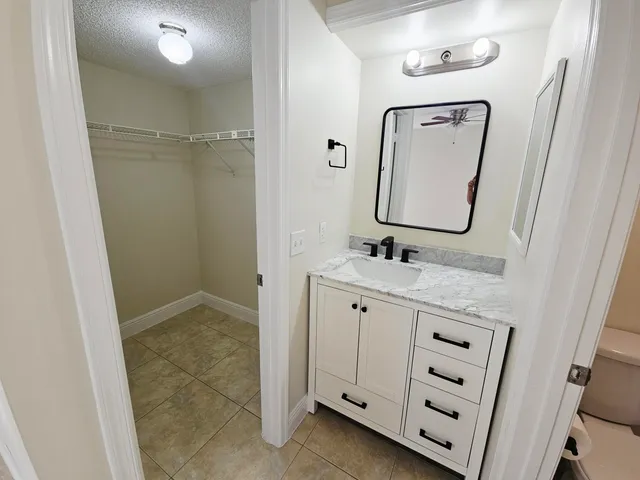 a bathroom with a double vanity sink a mirror and shower