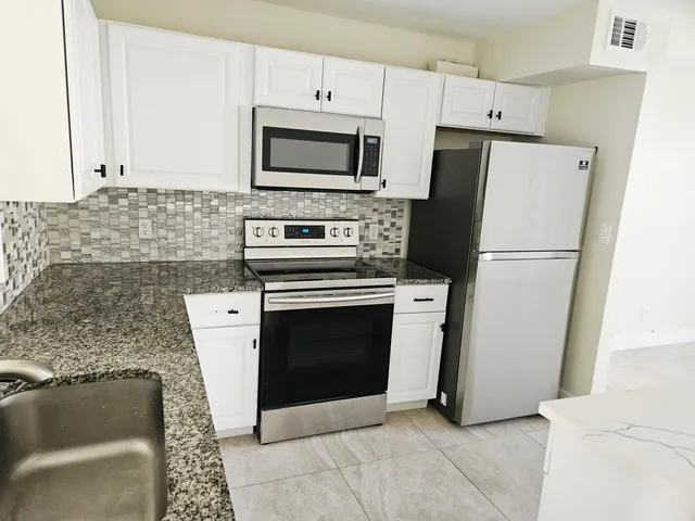 a kitchen with a stove microwave and refrigerator