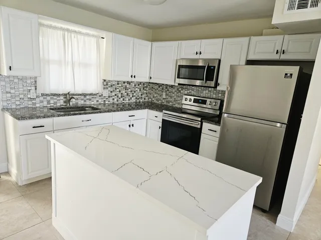 a kitchen with a refrigerator sink and microwave