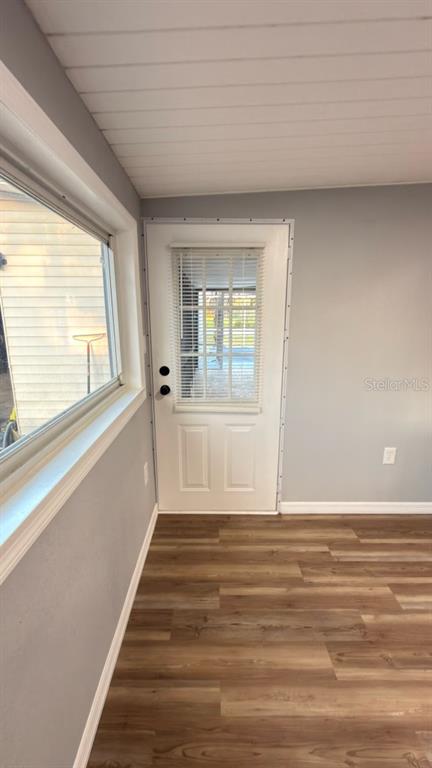 14740 Johns Road Dade City, FL 33525 - Photo 14 of 46 a view of an empty room with wooden floor and a window