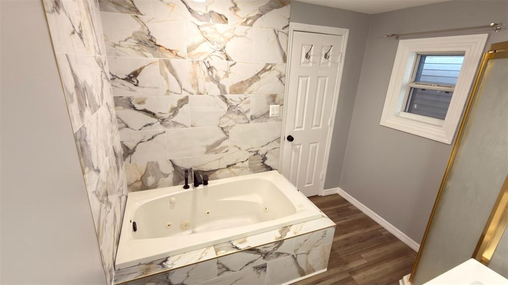 14740 Johns Road Dade City, FL 33525 - Photo 17 of 46 a bathroom with a sink and a mirror