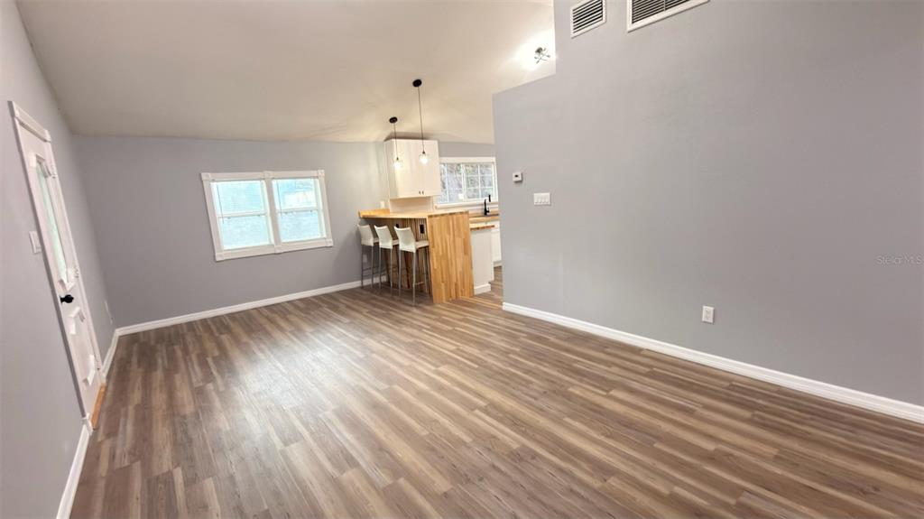 14740 Johns Road Dade City, FL 33525 - Photo 27 of 46 an empty room with wooden floor and windows
