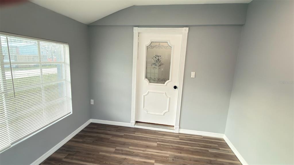 14740 Johns Road Dade City, FL 33525 - Photo 30 of 46 a view of a hallway with wooden floor and a window