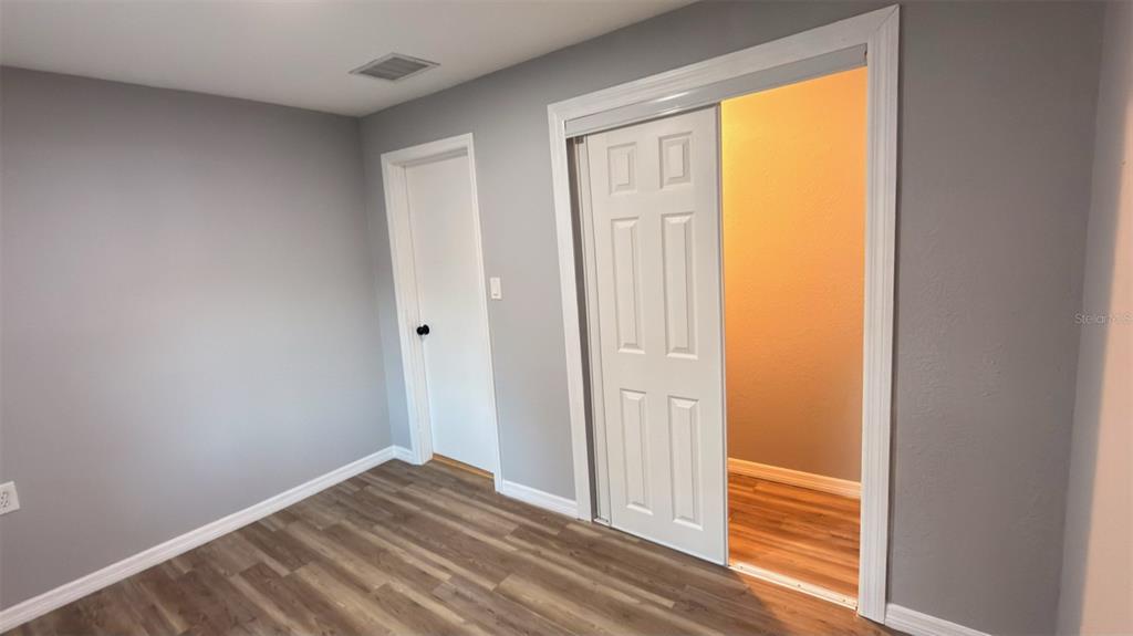 14740 Johns Road Dade City, FL 33525 - Photo 31 of 46 a view of empty room with wooden floor and fan