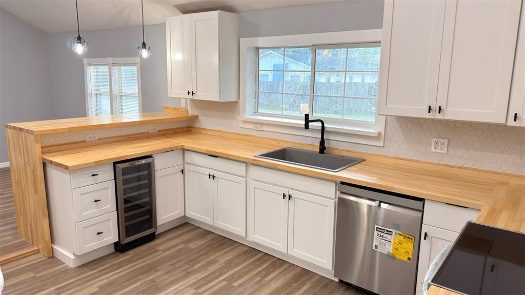14740 Johns Road Dade City, FL 33525 - Photo 7 of 46 a kitchen with stainless steel appliances granite countertop a sink a stove and cabinets