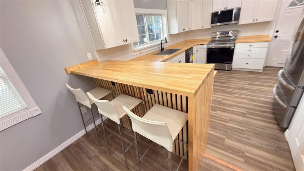 14740 Johns Road Dade City, FL 33525 - Photo 8 of 46 a dining room with furniture and wooden floor