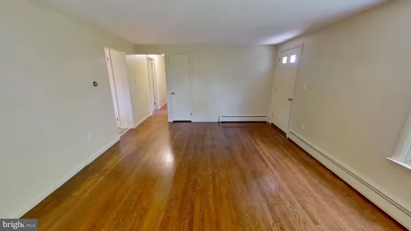 a view of a room with wooden floor