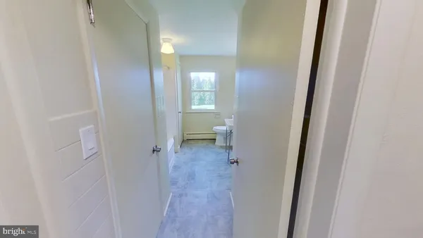 a view of a bathroom from the hallway