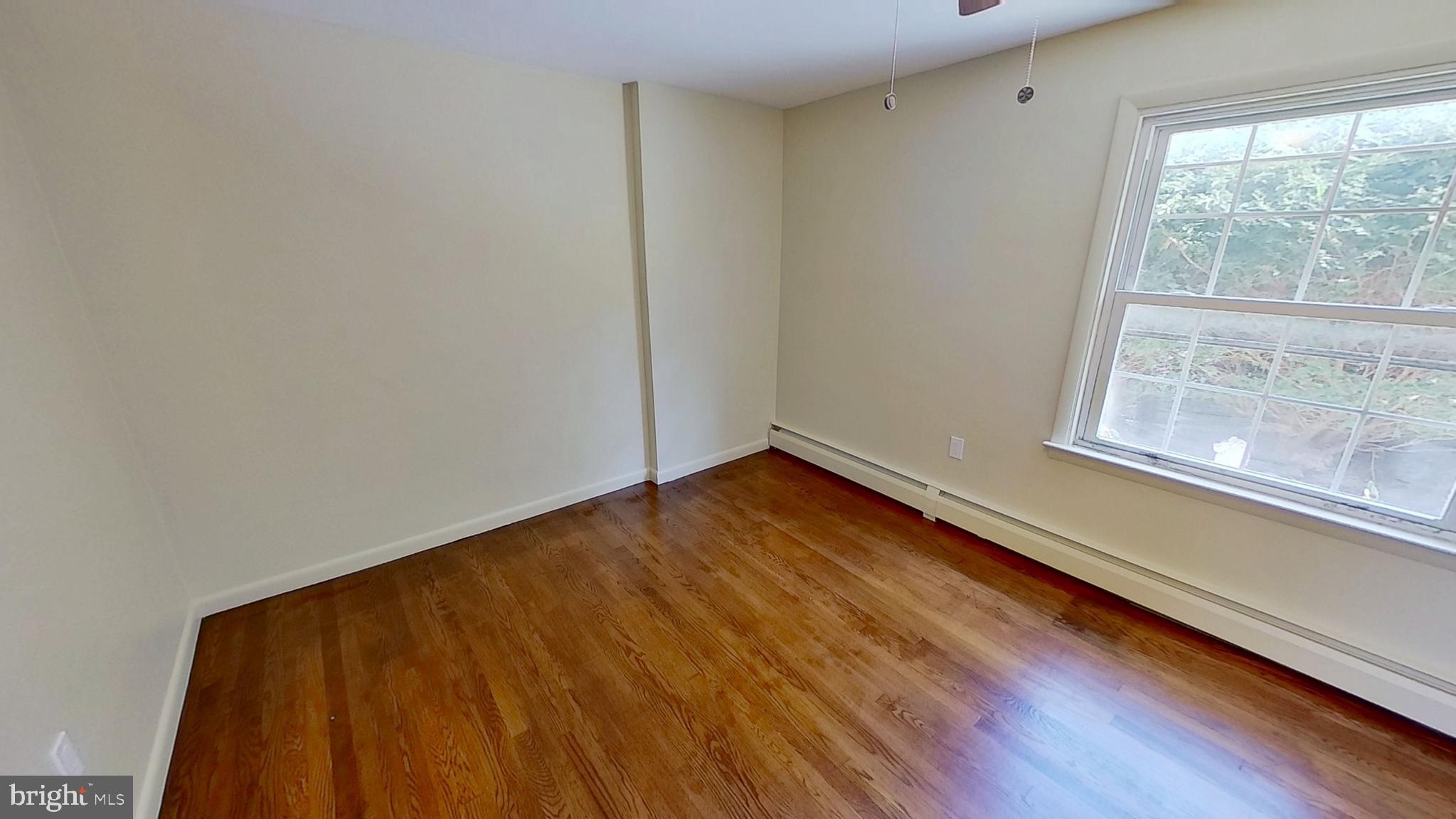 2174 South Queen Street, Unit A York, PA 17402 - Photo 9 of 9 a view of room with window and wooden floor