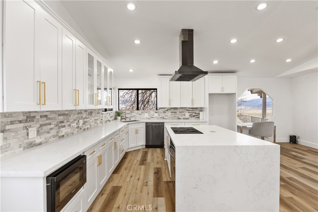 29300 Elkhorn Place Tehachapi, CA 93561 - Photo 14 of 47 a kitchen with white cabinets sink and stove