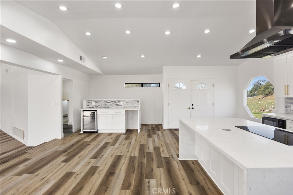 29300 Elkhorn Place Tehachapi, CA 93561 - Photo 15 of 47 a large white kitchen with a lot of counter space and wooden floor