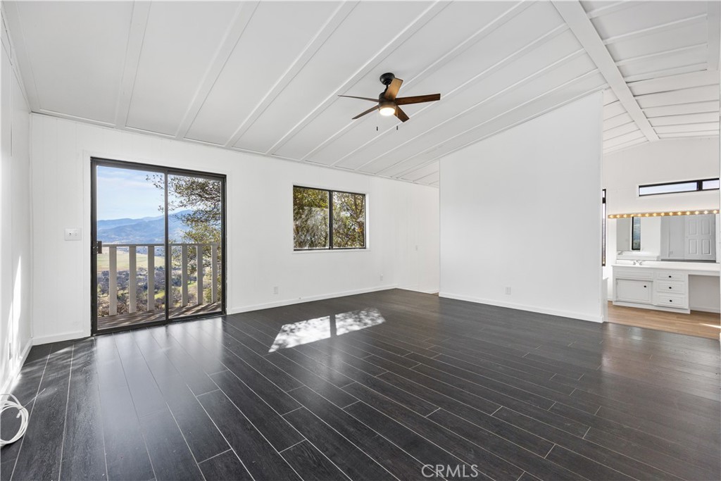 29300 Elkhorn Place Tehachapi, CA 93561 - Photo 16 of 47 a view of an empty room with wooden floor and a window