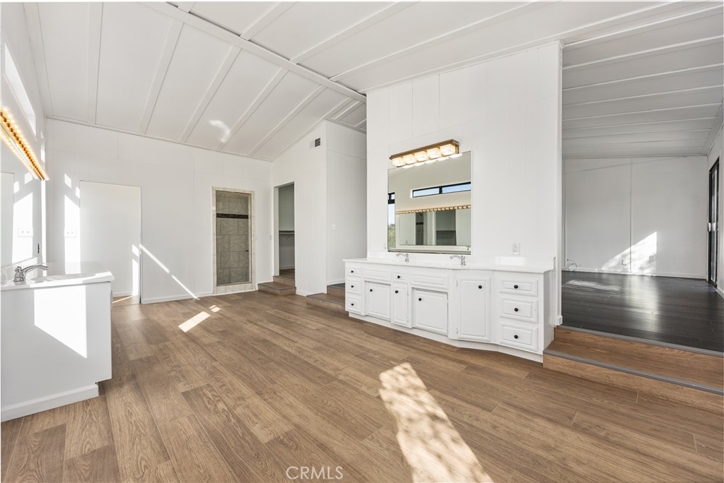 29300 Elkhorn Place Tehachapi, CA 93561 - Photo 21 of 47 a spacious bathroom with a double vanity sink and a mirror