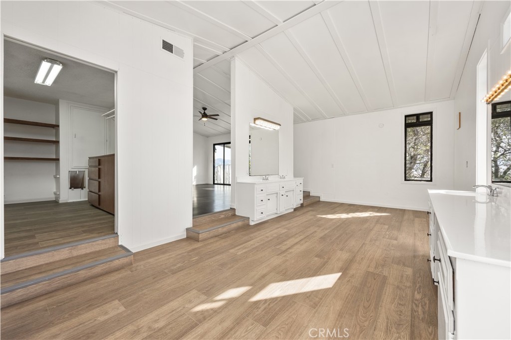 29300 Elkhorn Place Tehachapi, CA 93561 - Photo 22 of 47 a view of a big room with wooden floor and windows