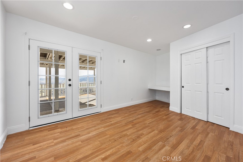 29300 Elkhorn Place Tehachapi, CA 93561 - Photo 32 of 47 a view of an empty room with wooden floor and a window