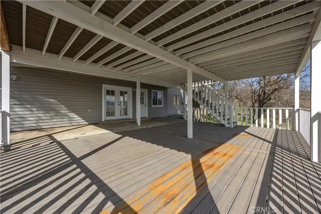 a view of a balcony with furniture and wooden floor