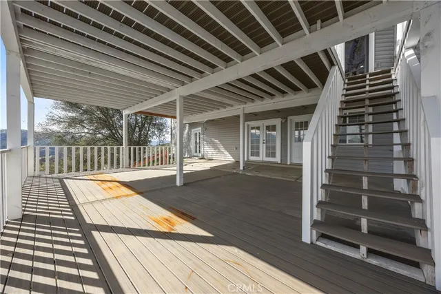 a view of a patio with lawn chairs and wooden floor