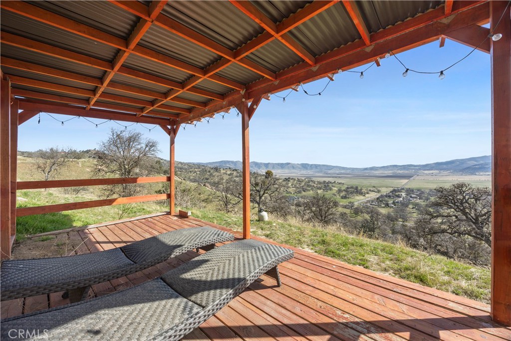 29300 Elkhorn Place Tehachapi, CA 93561 - Photo 47 of 47 a view of a patio with lawn chairs and wooden floor