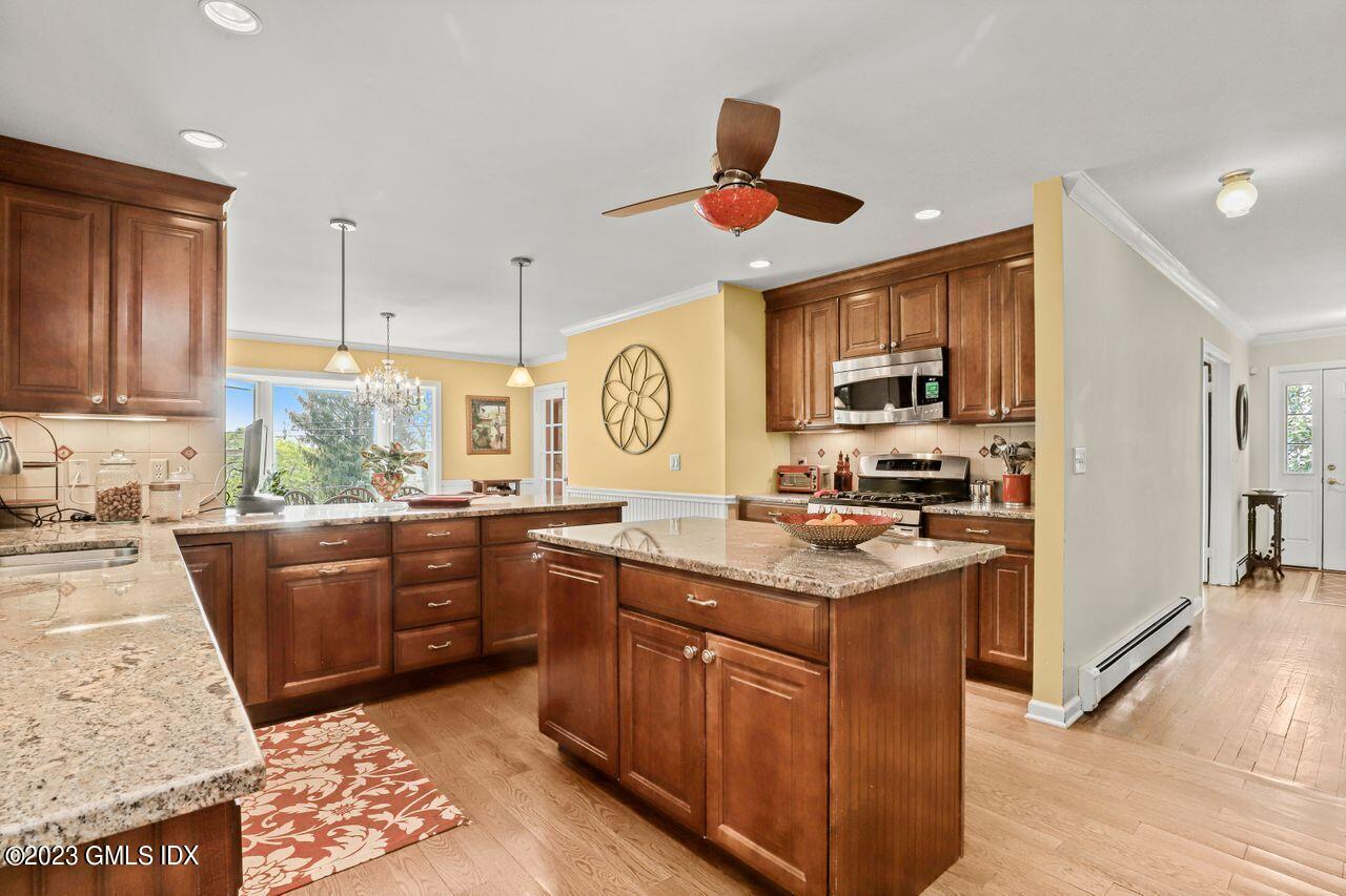 14 Marks Road Riverside, CT 06878 - Photo 11 of 24 a kitchen with stainless steel appliances granite countertop wooden cabinets a stove top oven a sink and dishwasher