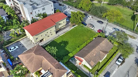 an aerial view of a house with a garden and swimming pool