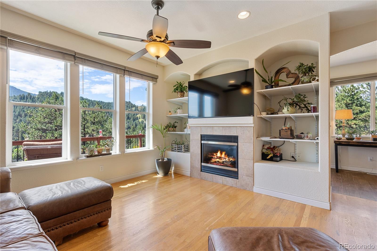 3345 Russell Gulch Road, Unit A Evergreen, CO 80439 - Photo 12 of 34 a living room with furniture and a fireplace