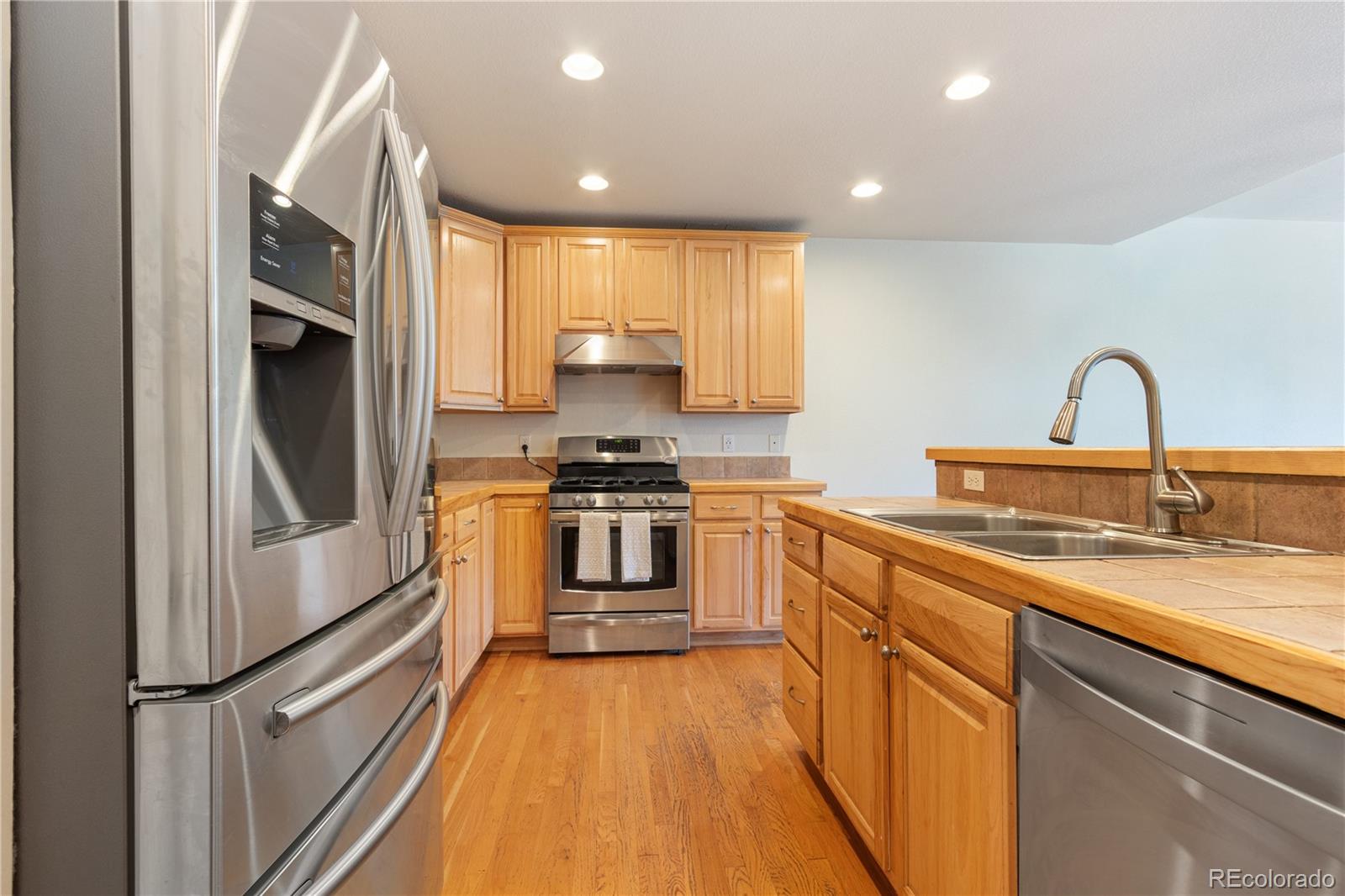 3345 Russell Gulch Road, Unit A Evergreen, CO 80439 - Photo 16 of 34 a kitchen with a refrigerator sink and white cabinets