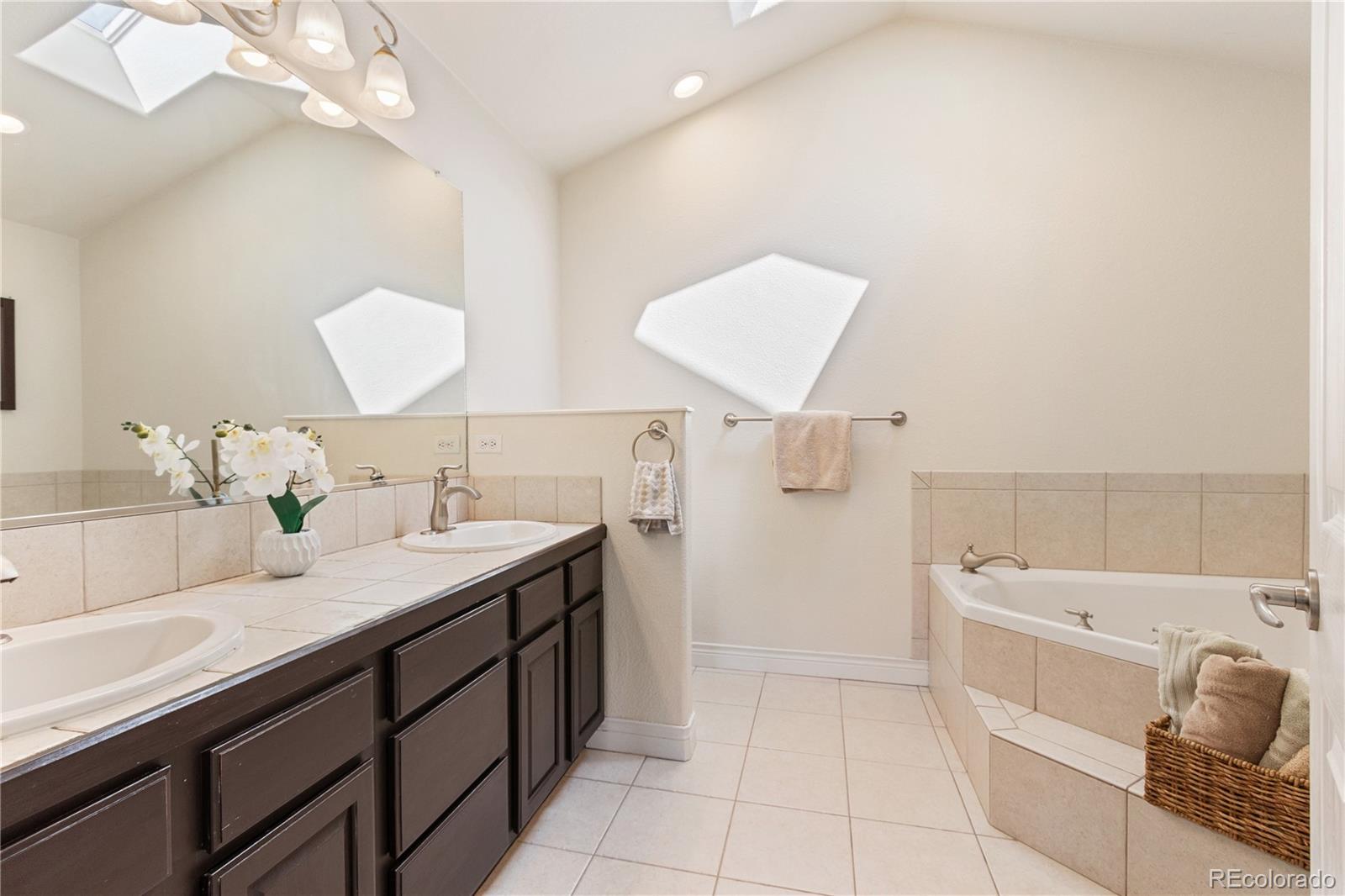 3345 Russell Gulch Road, Unit A Evergreen, CO 80439 - Photo 20 of 34 a spacious bathroom with a sink double vanity and a mirror