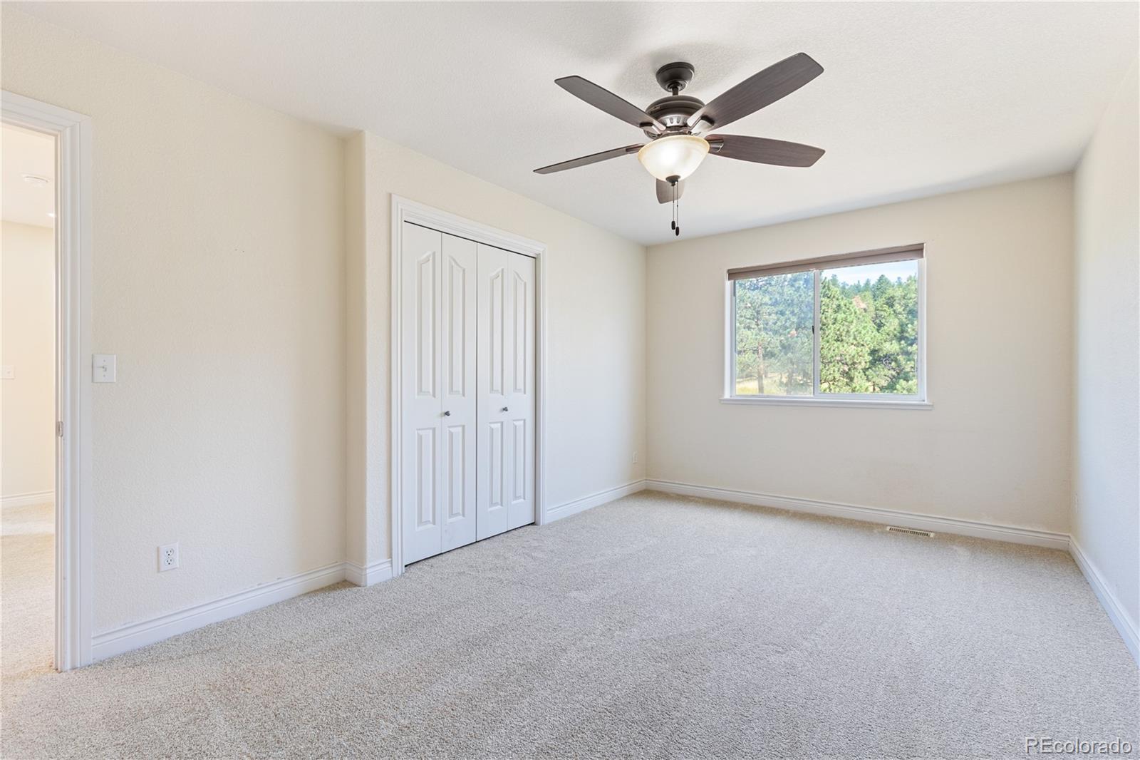 3345 Russell Gulch Road, Unit A Evergreen, CO 80439 - Photo 23 of 34 an empty room with windows and fan