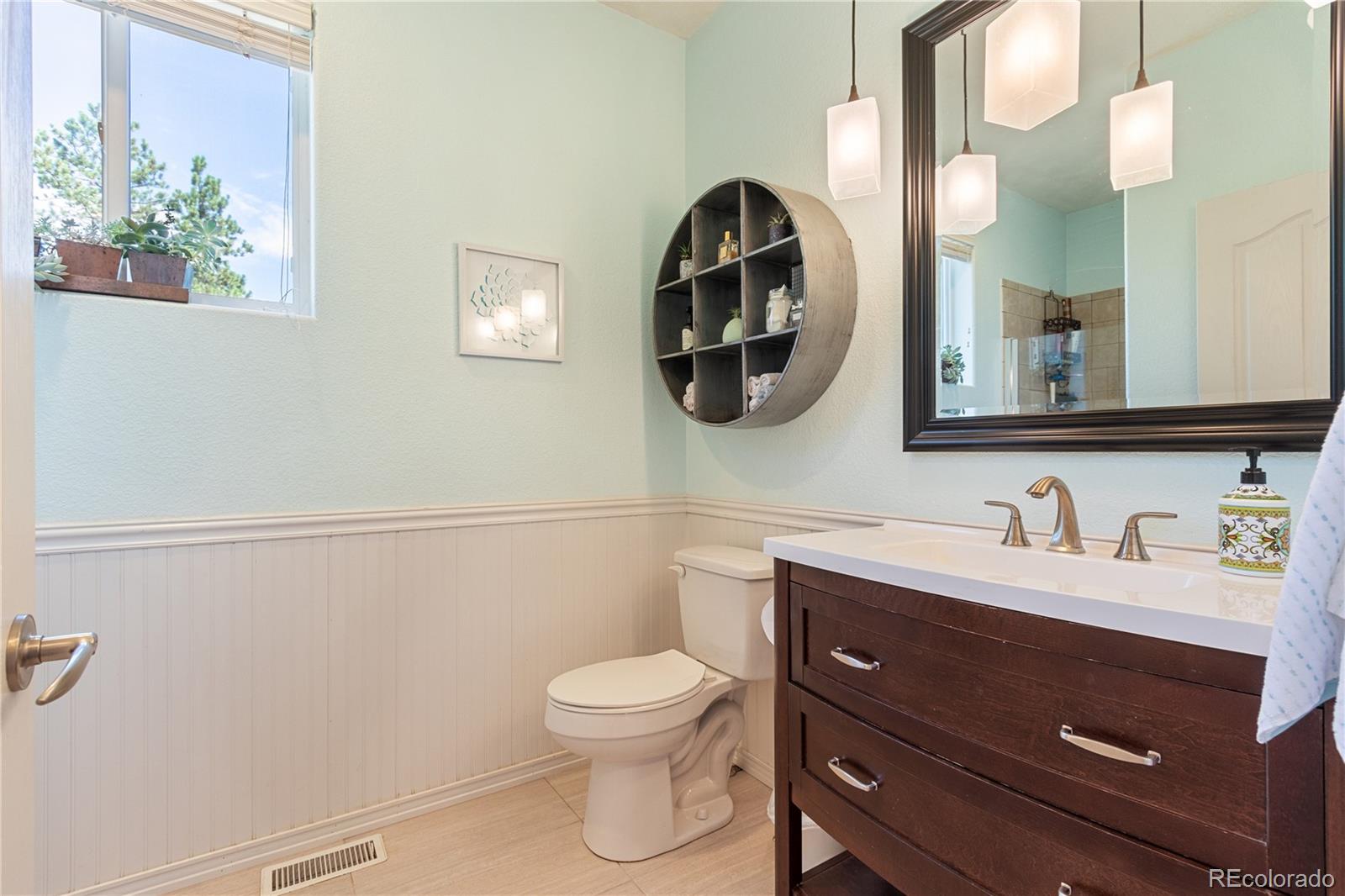3345 Russell Gulch Road, Unit A Evergreen, CO 80439 - Photo 27 of 34 a bathroom with a toilet a sink and mirror