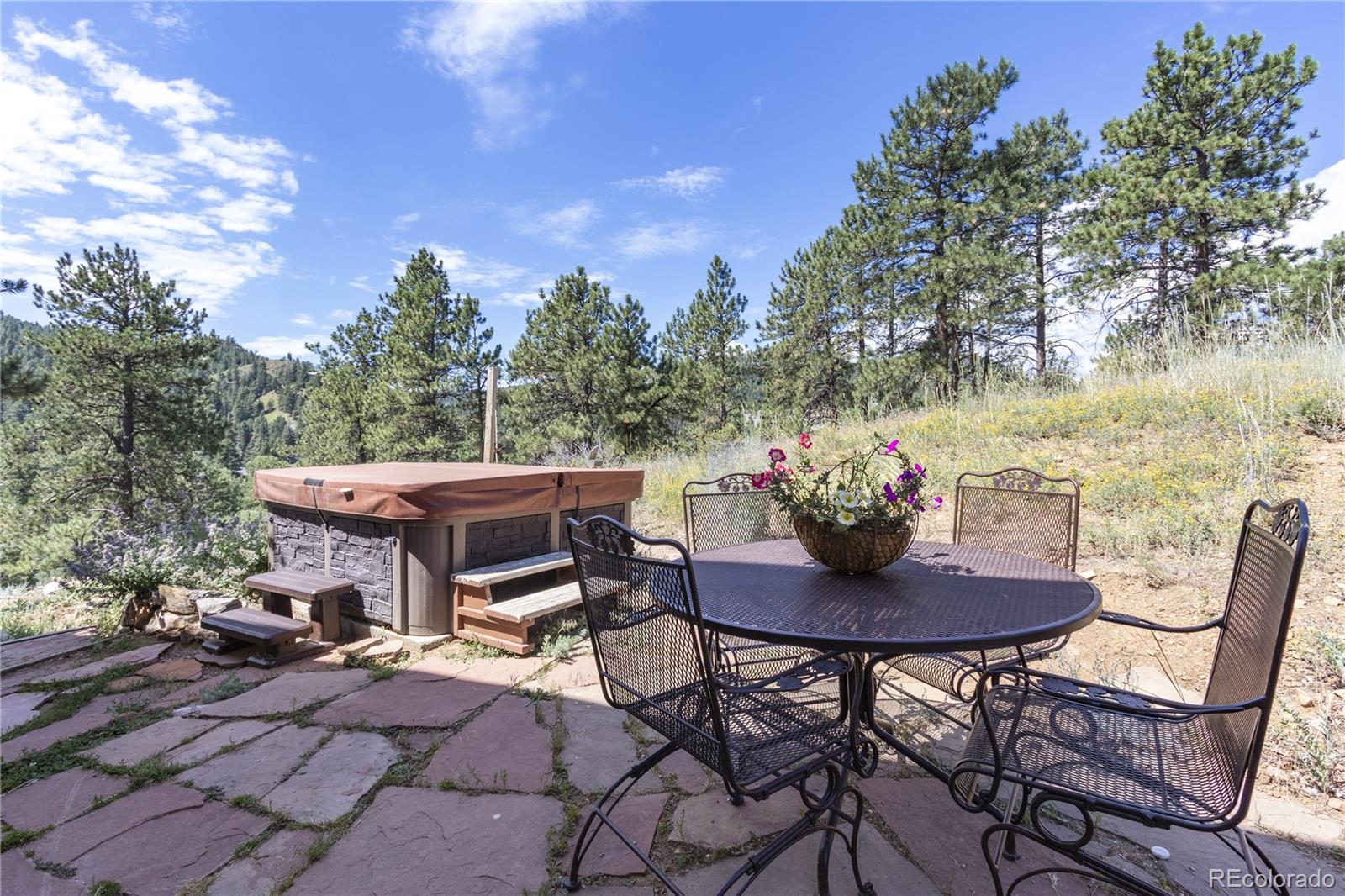 3345 Russell Gulch Road, Unit A Evergreen, CO 80439 - Photo 30 of 34 a view of a patio with furniture and a yard