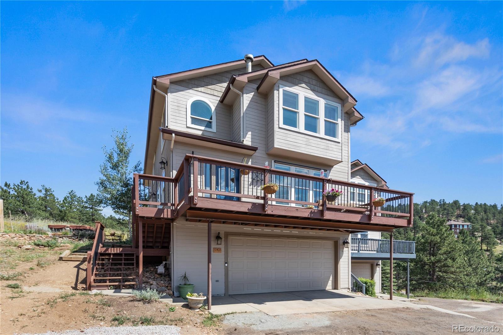 3345 Russell Gulch Road, Unit A Evergreen, CO 80439 - Photo 3 of 34 a front view of a house with a balcony