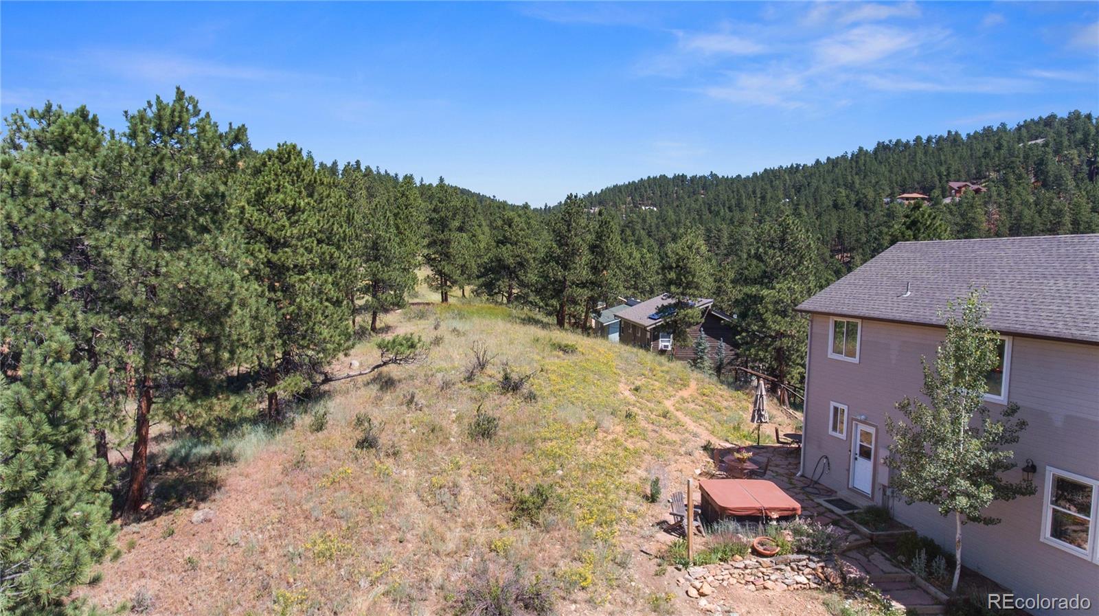 3345 Russell Gulch Road, Unit A Evergreen, CO 80439 - Photo 32 of 34 a view of a yard with a house